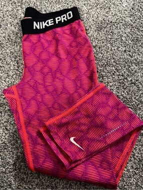 Nike Pro leggings with pink and orange geometric pattern, size M